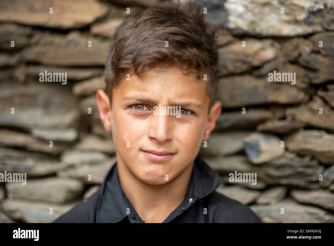 Portrait of a young Kalash boy with light eyes, Bumburet Valley, Pakistan Stock Photo