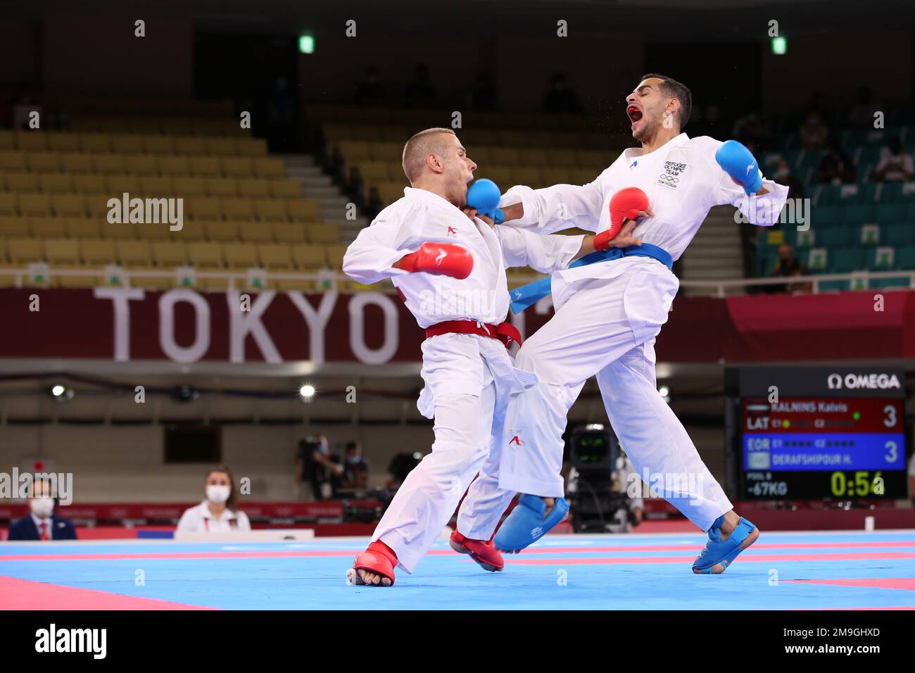 AUG 5, 2021 - TOKYO, JAPAN: Kalvis KALNINS of Latvia (red) and Hamoon DERAFSHIPOUR of the Refugee Olympic Team (blue) compete in the Karate Men's Kumi Stock Photo