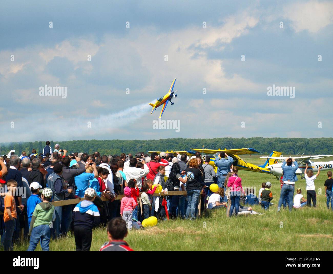 Light aircraft performing acrobatic flying during air show on Strejnic airfield near Ploiesti, Romania Stock Photo