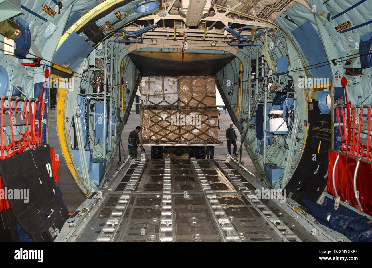 010921-F-3573Z-002. [Complete] Scene Caption: Inside view as members of the 37th Airlift Squadron, Ramstein Air Base, Germany, guide a 10K-AT forklift with a pallet load of medical supplies up to the ramp of a C-130 Hercules. The supplies are going to Pleven, Bulgaria in support of the humanitarian assistance program Excess Property. 'The Department of Defense Humanitarian Assistance Excess Property (EP) Program permits Department of Defense (DoD) to make available, prepare and transport non-lethal, excess DoD property to foreign countries when requested by the Department of State (DoS). Examp Stock Photo