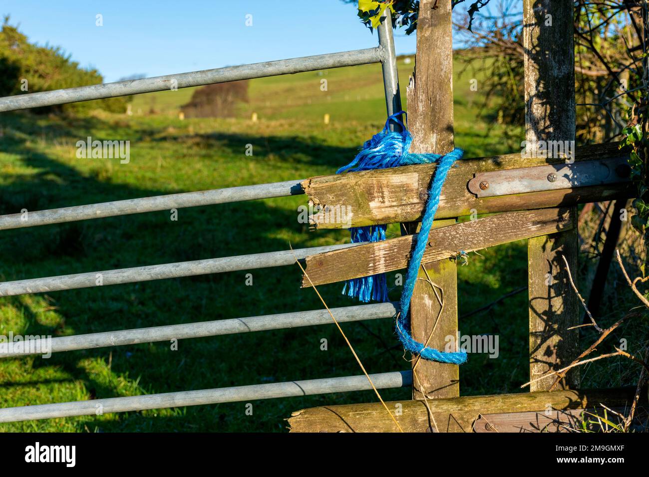 Fence and gate repairs on a farm in County Donegal, Ireland Stock Photo