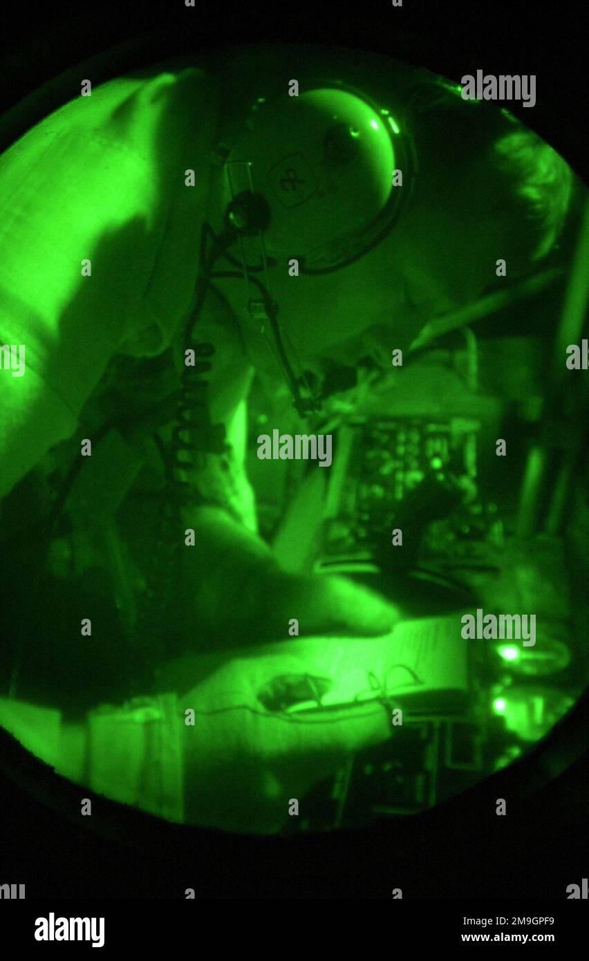 Viewed through the green glow of a night scope, STAFF Sergeant Max Morkin, a boom operator from the 319th Air Refueling Squadron, 319th Air Expeditionary Group (AEG), uses the dim red nightlights to finalize his refueling checklist, prior to a night aerial refueling of an E-C3 (AWACS). The 319th AEG deployed to a classified location in support of Operation ENDURING FREEDOM, which is in support of the Global War on Terrorism (GWOT), fighting terrorism abroad. Subject Operation/Series: ENDURING FREEDOM Country: Unknown Scene Major Command Shown: AMC Stock Photo