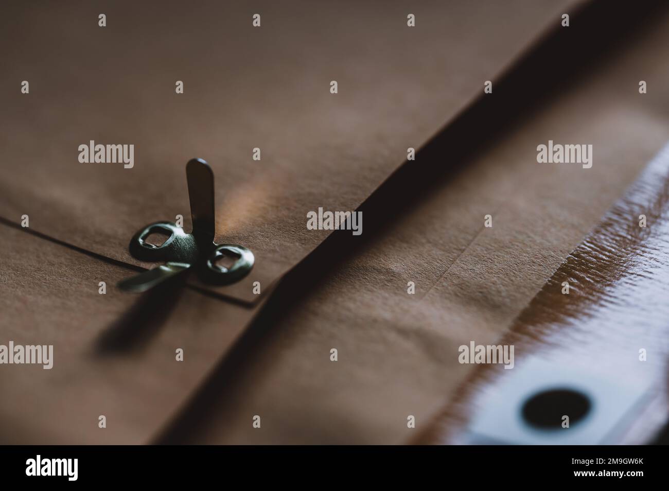 manilla envelope with reinforced hole and metal folding clasp Stock