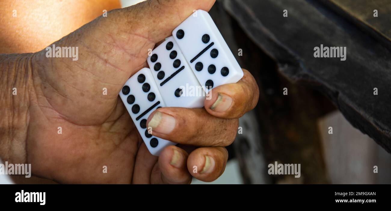 Man holding domino blocks while playing game, La Passe, La Digue, Seychelles Stock Photo