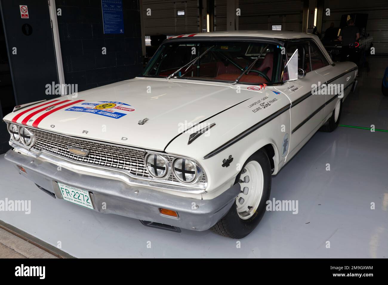 Three-quarters front view of Fred and Bill Shepherd's White, 1965, Ford Galaxie, in the International Pits, at the 2022 Silverstone Classic Stock Photo