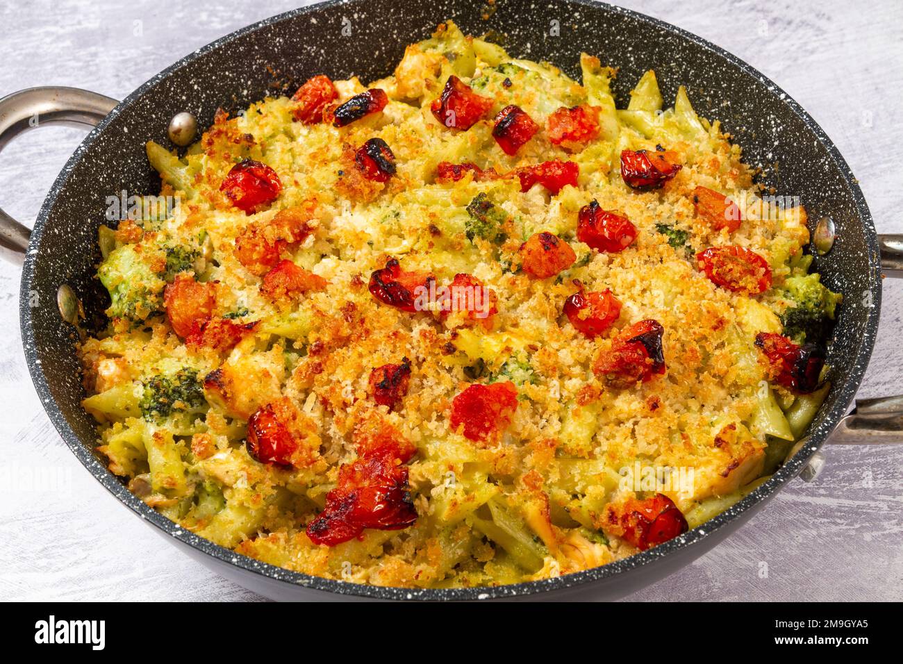 Pesto salmon pasta bake Stock Photo