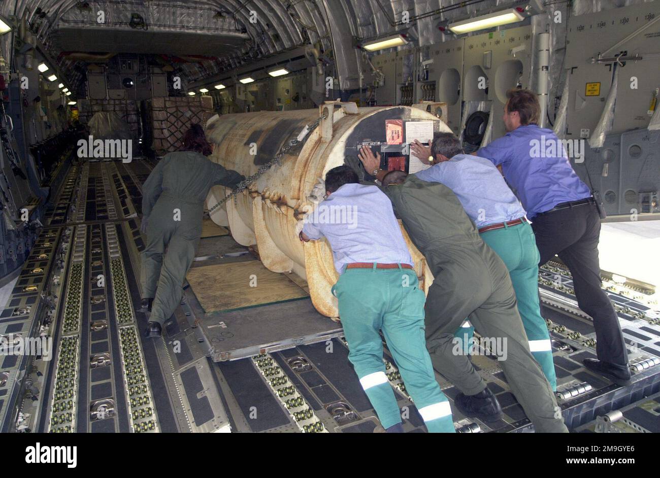 SENIOR AIRMAN Vikki Bruemmer, US Air Force (USAF), loadmaster, 17th Airlift Squadron, Charleston AFB, South Carolina, along with local national workers, load a pallet of cargo into the C-17A Globemaster at Naval Air Station (NAS) Sigonella, Sicily. Air Force members deployed to NAS Sigonella in support of Operation ENDURING FREEDOM. In response to the terrorist attacks on September 11, 2001 at the New York World Trade Center and the Pentagon, President George W. Bush initiated Operation ENDURING FREEDOM in support of the Global War on Terrorism (GWOT), fighting terrorism abroad. Subject Operat Stock Photo