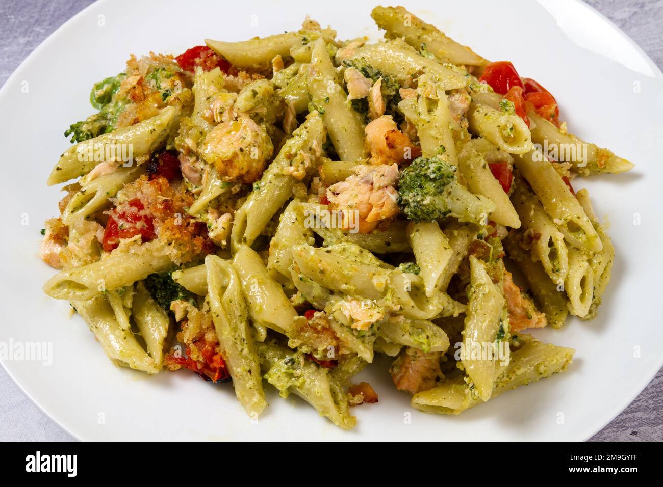 Pesto salmon pasta bake, plated Stock Photo Alamy