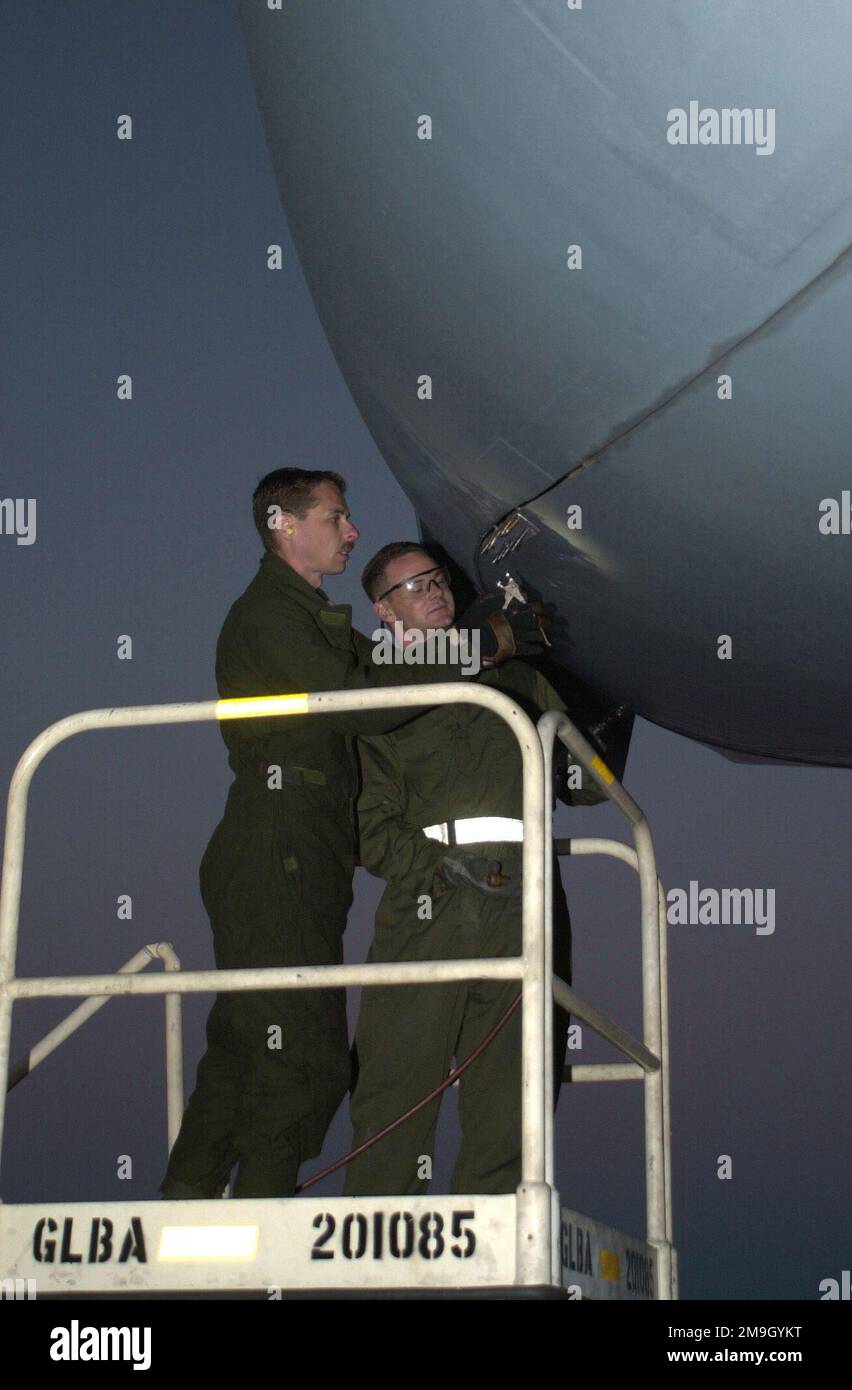 SENIOR AIRMAN Derek Turnipseed, USAF, (right), structural maintenance specialist, and Technical Sergeant Tim Ferguson, USAF, crewchief, both with the 437th Maintenance Squadron, Charleston AFB, South Carolina, make repairs to a C-17A Globemaster III on the ramp at Naval Air Station Sigonella, Sicily. Air Force members deployed to Naval Air Station Sigonella in support of Operation ENDURING FREEDOM. Subject Operation/Series: ENDURING FREEDOM Base: Naval Air Station, Sigonella State: Sicily Country: Italy (ITA) Scene Major Command Shown: AMC Stock Photo