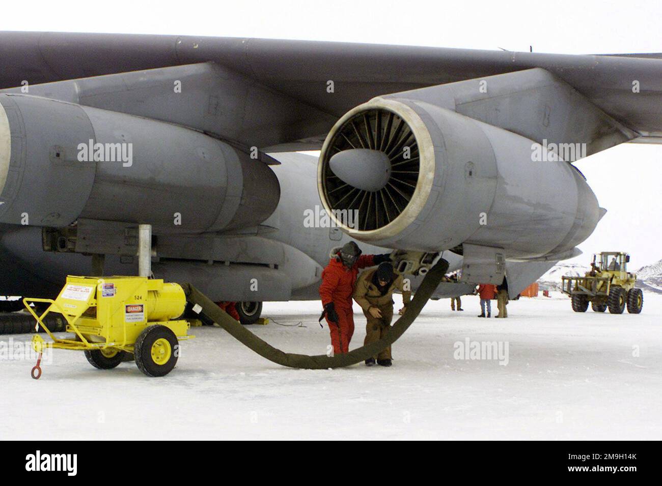 Ground crews install engine heaters on a Lockheed C141C Starlifter