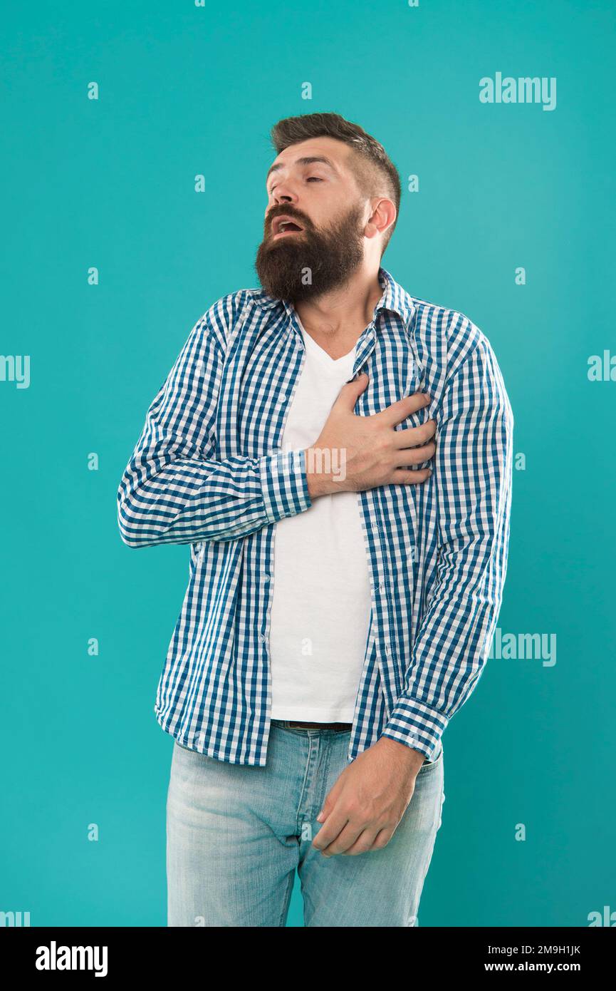 Heart health. Unhealthy hipster hold hand on chest. Suffering from