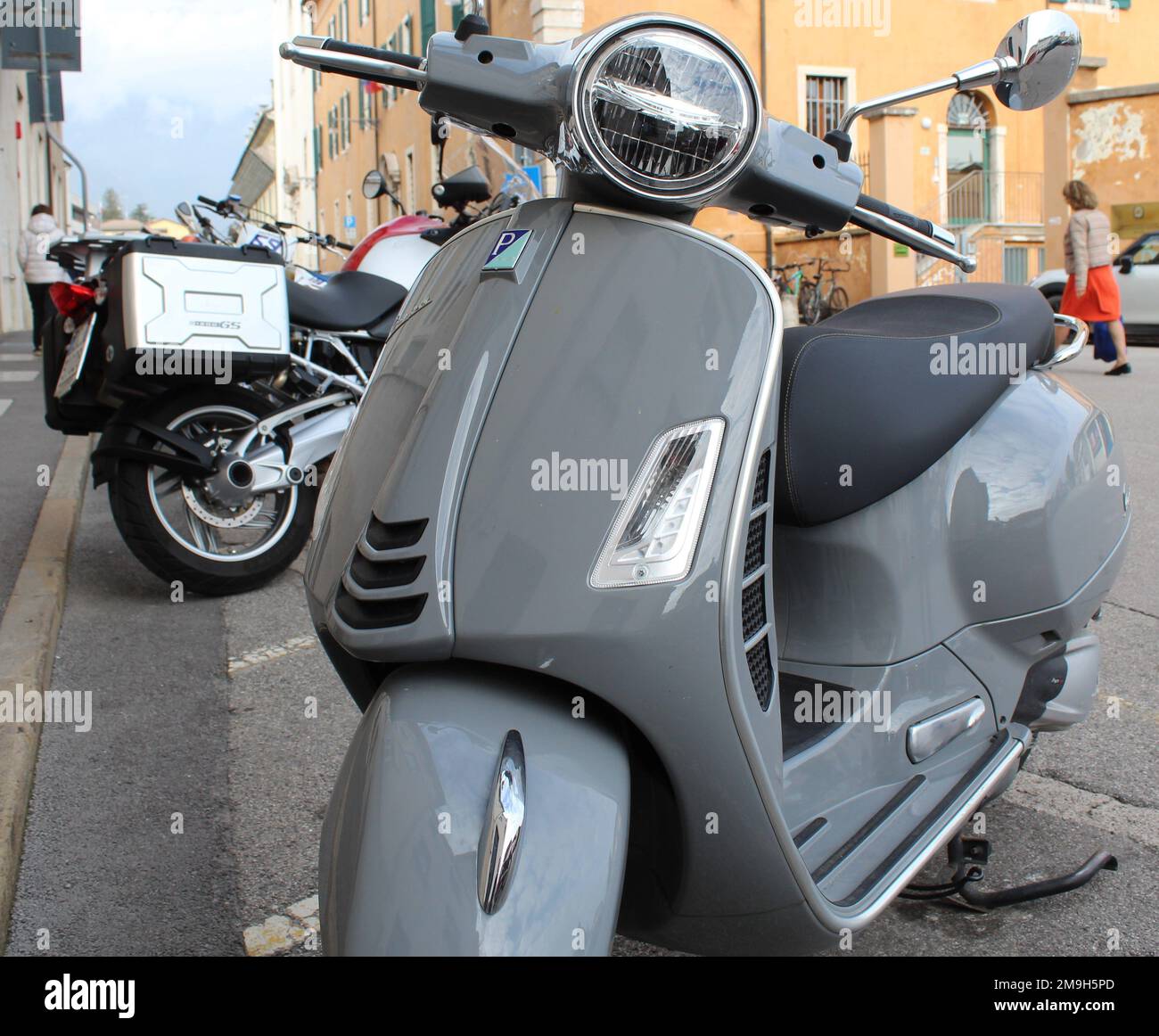 A closeup shot of a gray Vespa 50 motorbike parked on the streets of Belluno, Italy Stock Photo