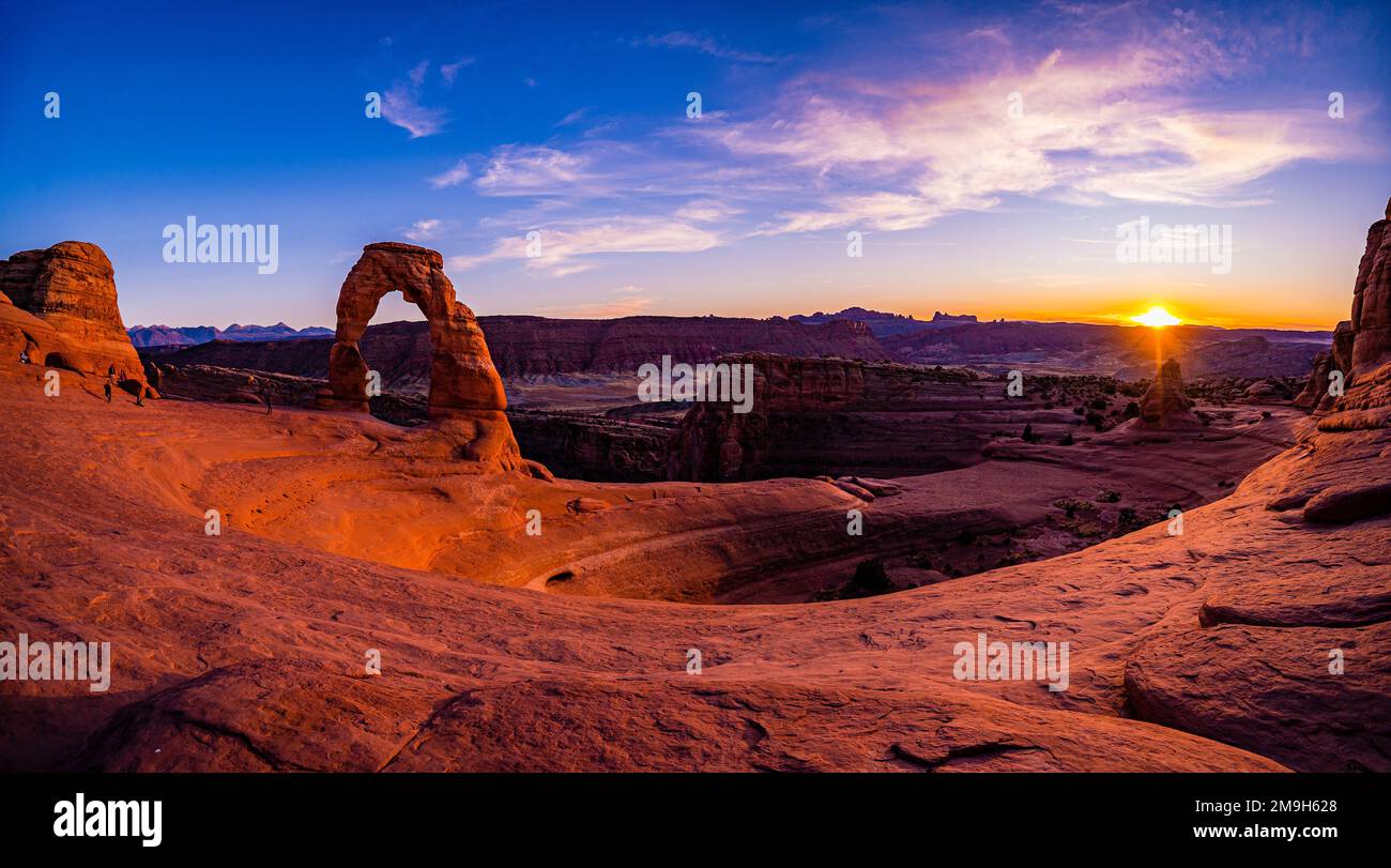 Landscape with natural arch in canyon at sunset, Delicate Arch, Arches National Park, Utah, USA Stock Photo