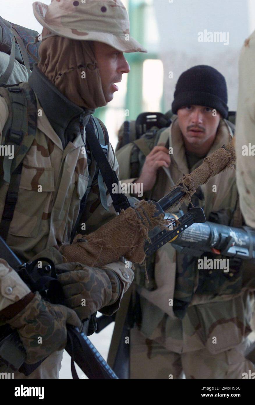 US Navy Corpsman Second Class Gartman, carrying an M16 and a Barrett