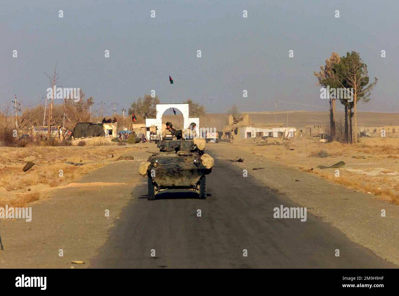 Marines with Alpha Company, Second Light Armored Reconnaissance Battalion, 26th Marine Expeditionary Unit (Special Operations Capable) drive their LAV-25 (Light Armored Vehicle-25) through and past the Afghan-manned gate at the Kandahar International Airport, Kandahar, Afghanistan, during OPERATION ENDURING FREEDOM. Subject Operation/Series: ENDURING FREEDOM Base: Kandahar International Airport Country: Afghanistan (AFG) Scene Major Command Shown: 26 MEU Stock Photo