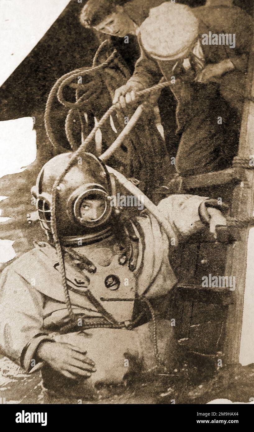 A 1930 British diver with his equipment including telephone, air pump, heavy weights etc.. Stock Photo