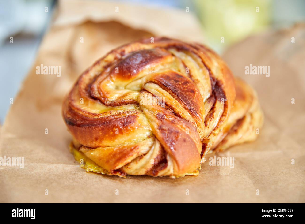 Danish cinnamon bun on a white plate Stock Photo