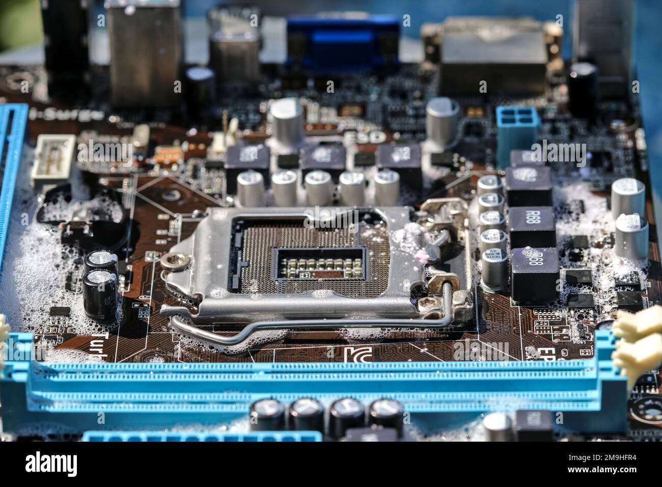 Clean the computer motherboard with water and detergent. Stock Photo