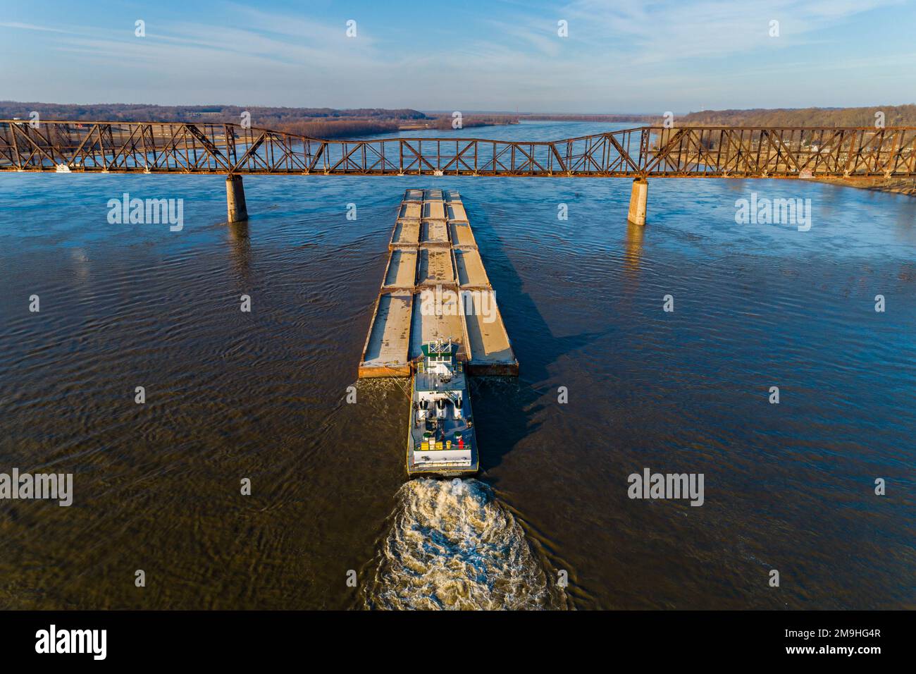Aerial view of barge on Mississippi River passing under Union Pacific RR bridge near Thebes, Alexander County, Illinois, USA Stock Photo