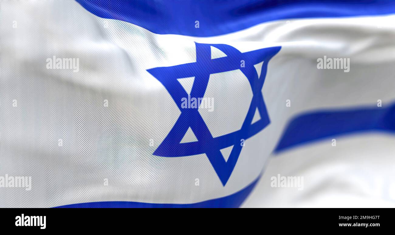 Detail of the Israel national flag waving. Blue hexagram on a white background, between two horizontal blue stripes. Rippled fabric. Textured backgrou Stock Photo