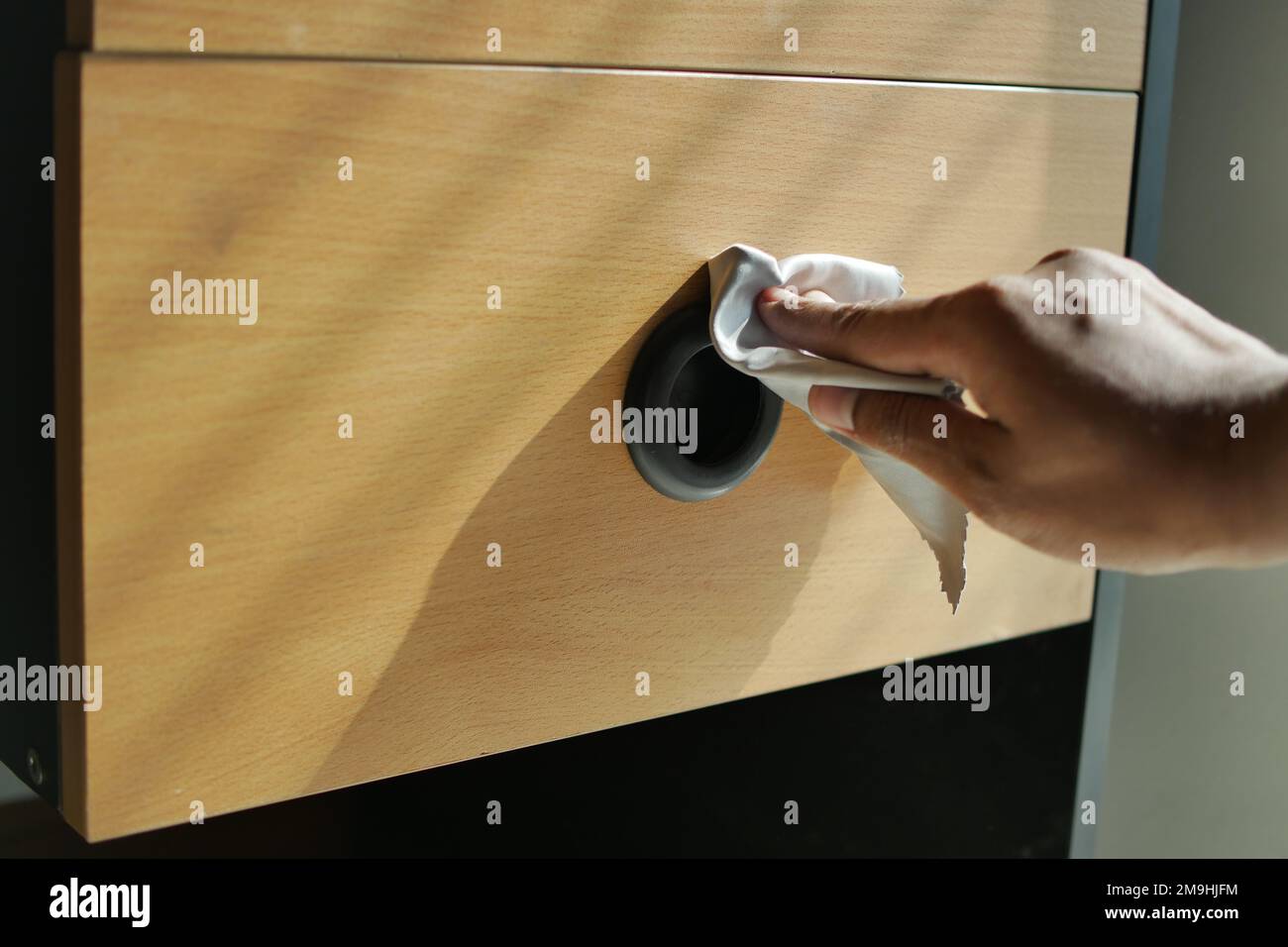 person hand cleaning drawer with a tissue Stock Photo Alamy