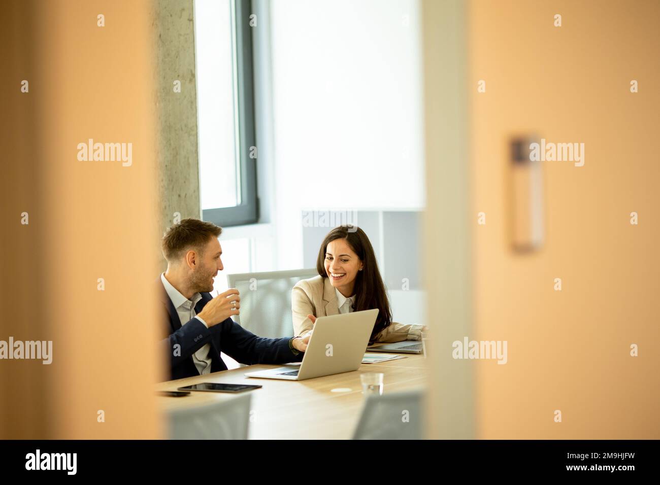 Businessman and businesswoman working together in office Stock Photo
