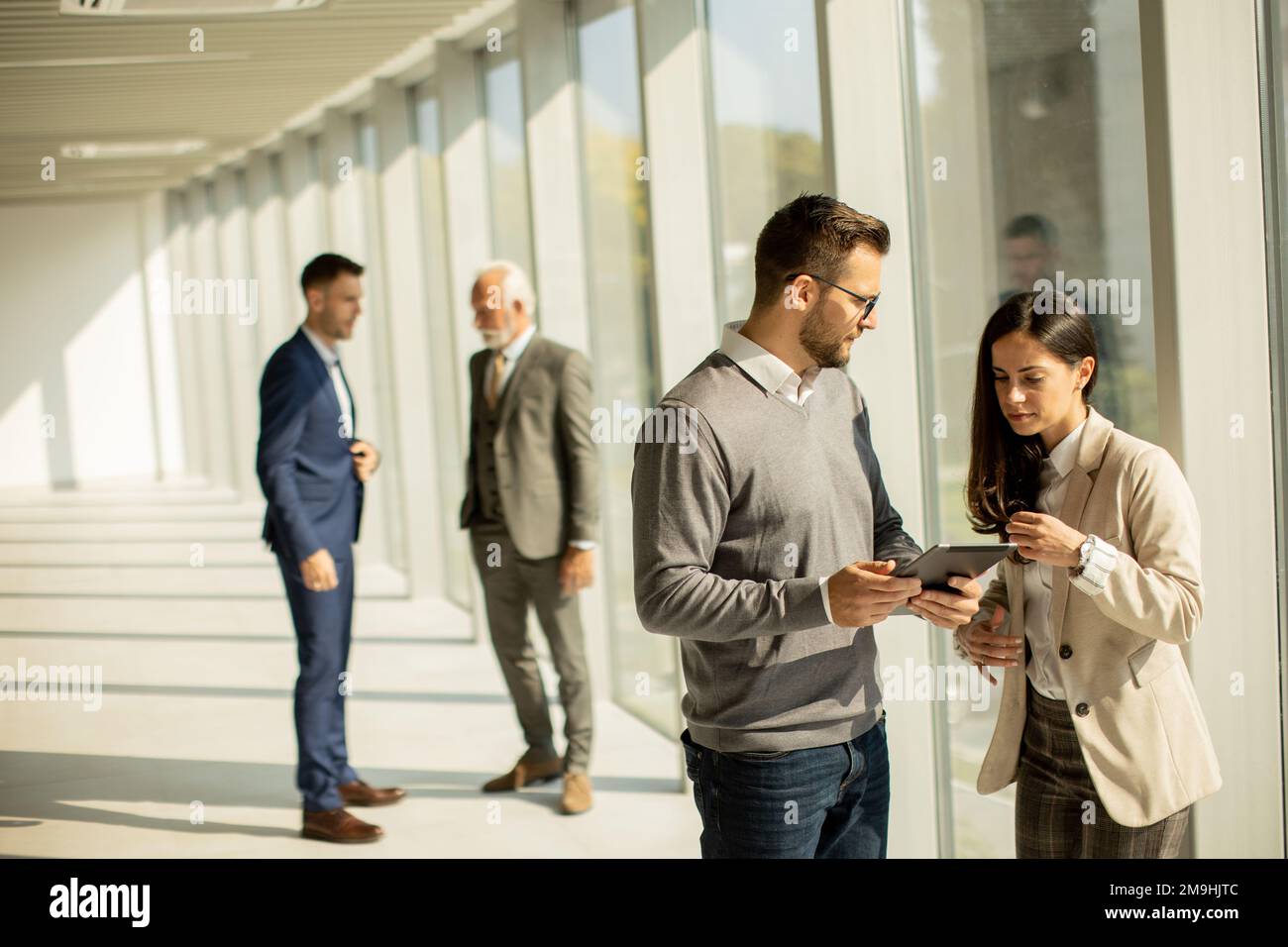 Handsome young modern business people using digital tablet in the office Stock Photo