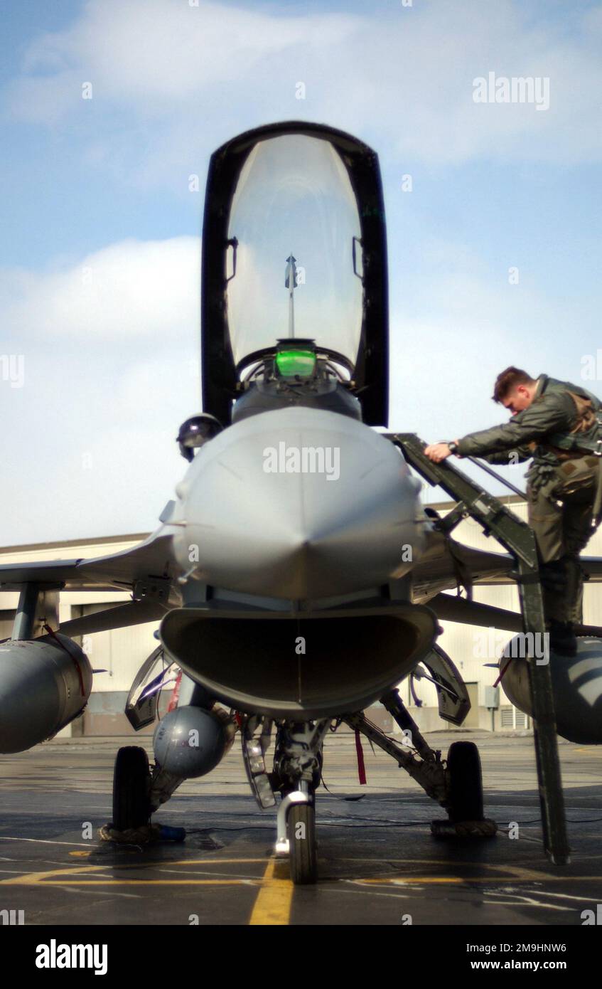A pilot from the 18th Fighter Squadron (FS) enters the cockpit of his ...