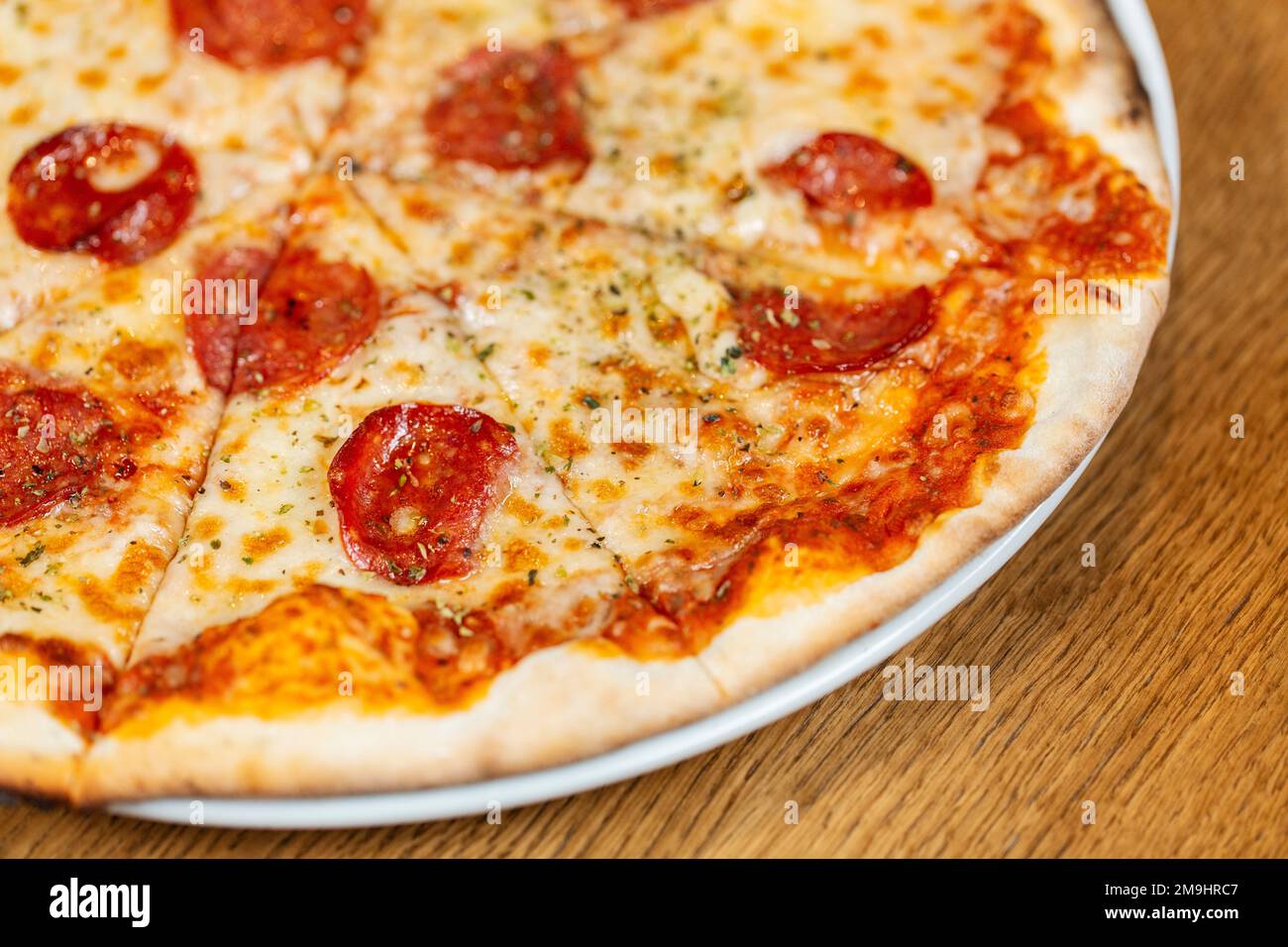 close up of sliced pizza margherita on plate Stock Photo