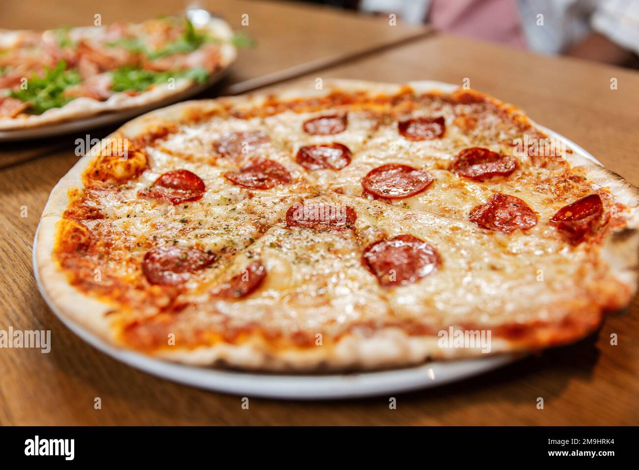 close up of pizza on wooden table Stock Photo