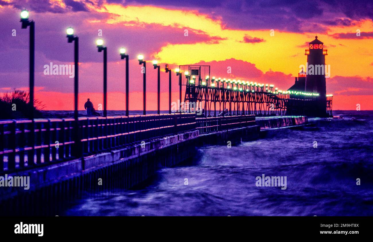 Wavy sea and Lighthouse at sunset in Grand Haven lighthouse, Michigan, USA Stock Photo
