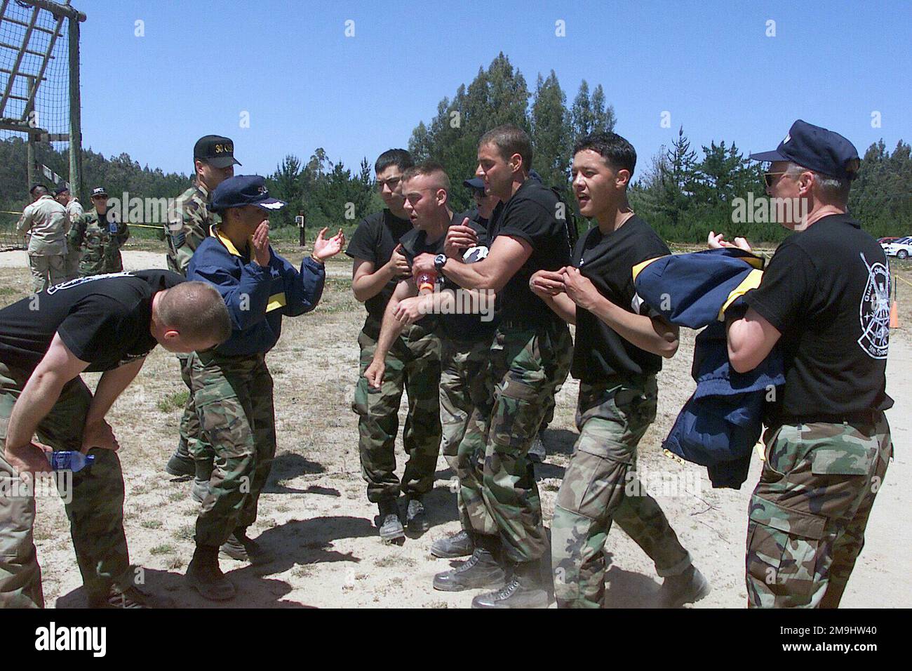 US Air Force (USAF) Security Police (SP) from the 50th Space Wing (SW), Schriever Air Force Base (AFB), Colorado (CO), are congratulated by USAF Colonel (COL) Diann Latham (center), 50th Space Wing Competition Commander, after completing the Obstacle Course competition at Vandenberg Air Force Base (AFB) California (CA), during Exercise GUARDIAN CHALLENGE 2002. Guardian Challenge, a four-day space and missile competition, is hosted annually at Vandenberg AFB, CA to test the wartime readiness of Air Force Space Command (AFSPC) professionals. US Air Force (USAF) Security Police (SP) from the 50th Stock Photo