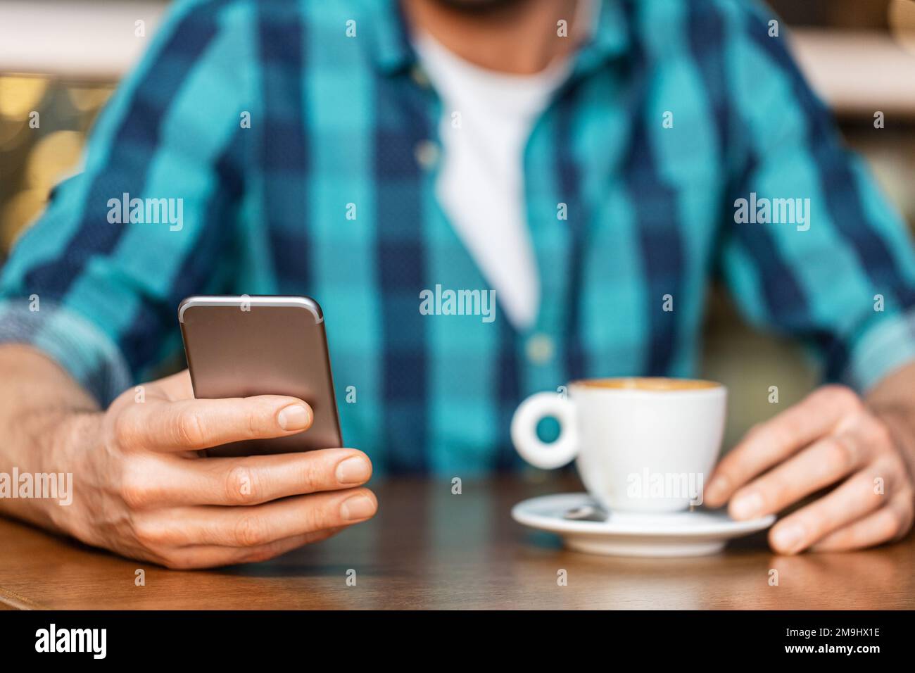 man with coffee and smartphone at restaurant Stock Photo