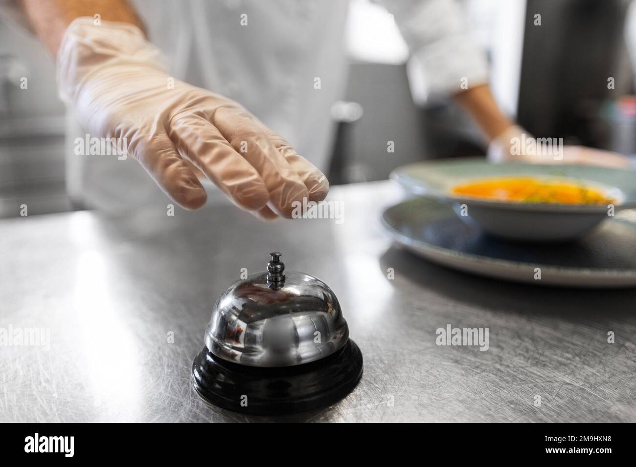 close up of chef ringing bell at restaurant Stock Photo