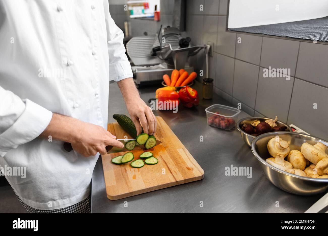 close up of chef cooking food on kitchen Stock Photo
