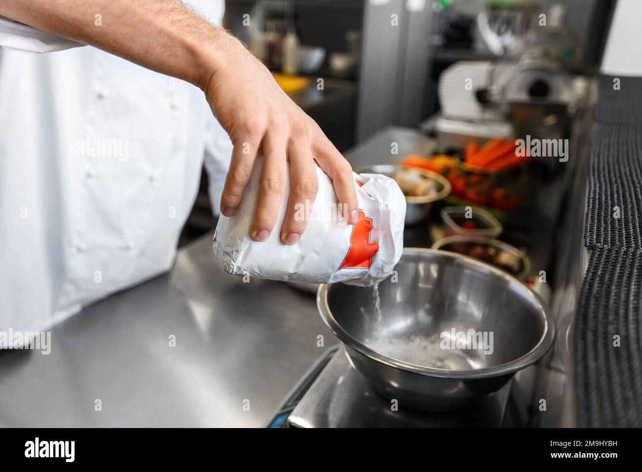 close up of chef cooking food at restaurant Stock Photo