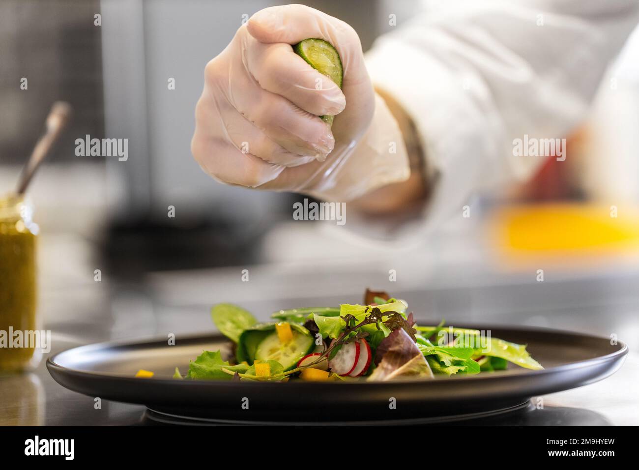 close up of chef dressing salad at restaurant Stock Photo