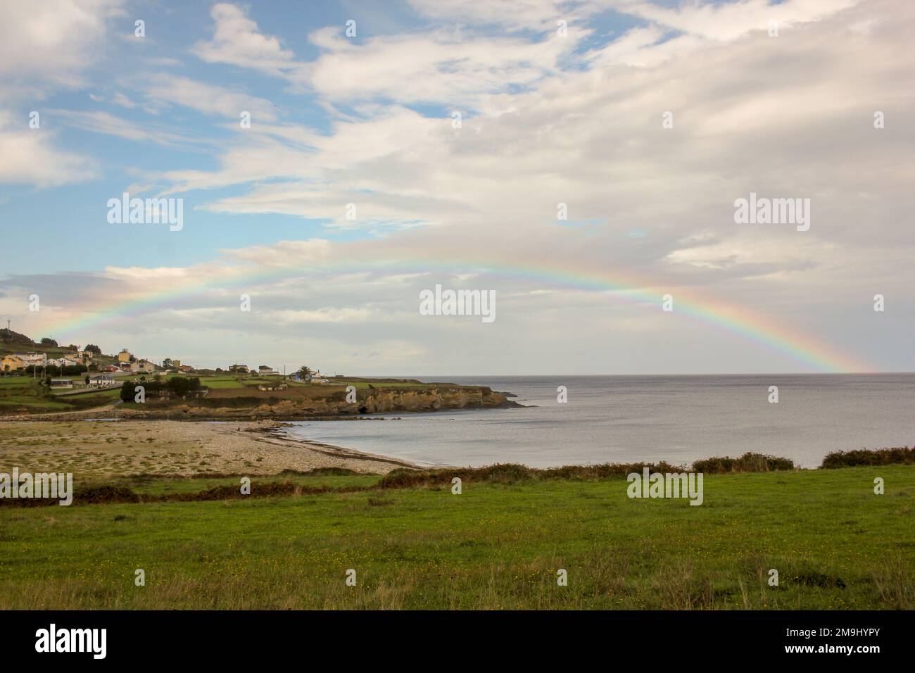 rainbow on the Cantabrian sea in Spain Stock Photo