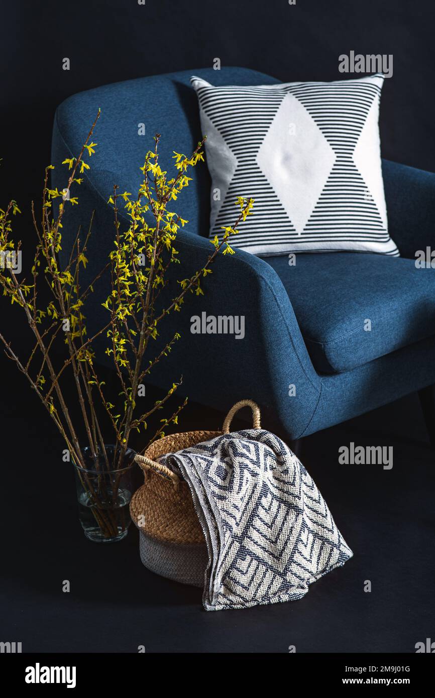 blue chair and blanket in basket over black wall Stock Photo