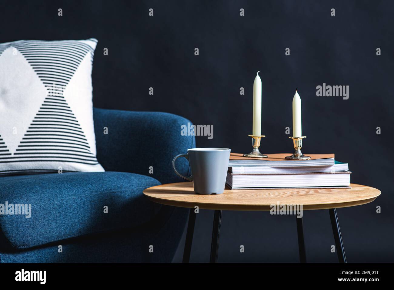 close up of chair and coffee table over black wall Stock Photo