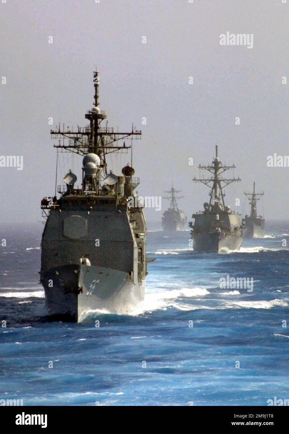 An armada of US Navy (USN) Ships steam in formation during an exercise conducted in the Atlantic Ocean. Pictured front-to-back the US Navy (USN) TICONDEROGA CLASS: GUIDED MISSILE CRUISER (AEGIS), USS SAN JACINTO (CG 56), the ARLEIGH BURKE CLASS (FLIGHT I) GUIDED MISSILE DESTROYER (AEGIS), USS MITSCHER (DDG 57), the OLIVER HAZARD ERRY CLASS: GUIDED MISSILE FRIGATE, USS HAWES (FFG 53), and the SPURANCE CLASS: DESTROYER, USS BRISCOE (DD 977). Country: Atlantic Ocean (AOC) Stock Photo