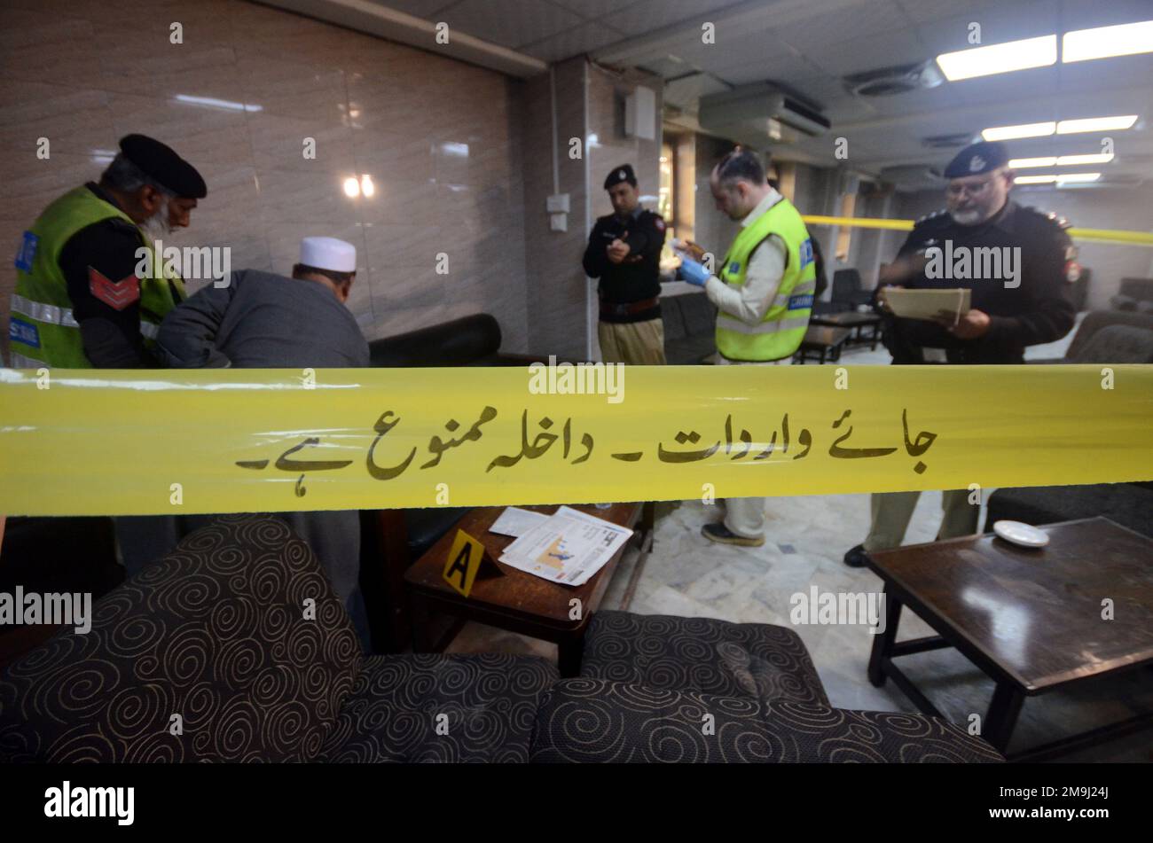 Pakistan. 16th Jan, 2023. Police officers examine the crime scene