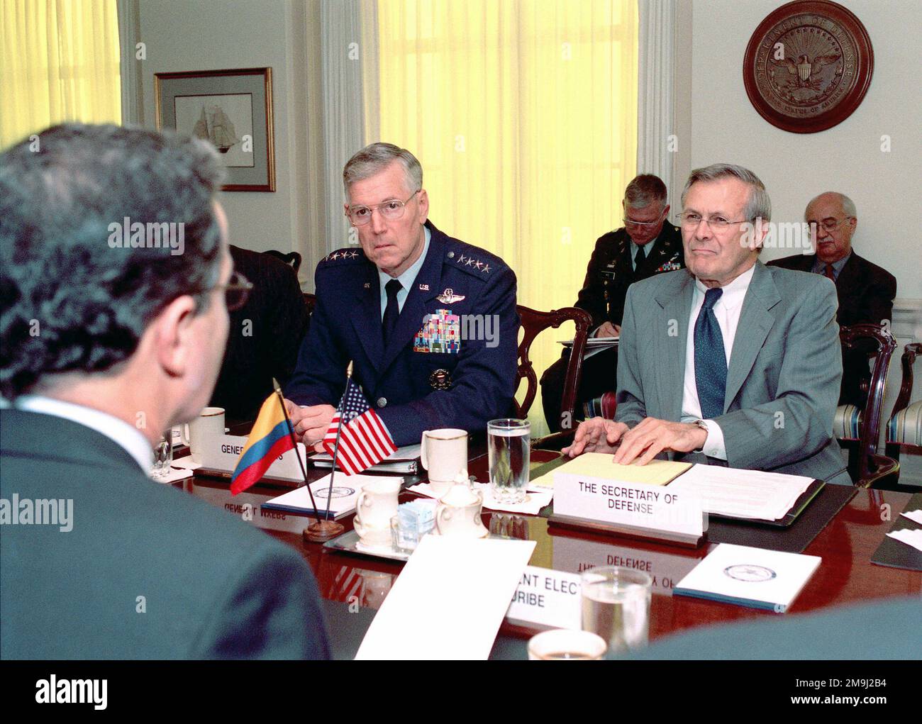 US Air Force (USAF) General (GEN) Richard B. Myers (left) Chairman of the Joint Chiefs of STAFF, and US Secretary of Defense, The Honorable Donald H. Rumsfeld, meet with Republic of Columbia, President-elect Alvaro Uribe, (foreground) during a defense meeting held at the Pentagon in Washington, District of Columbia (DC). US Air Force (USAF) General (GEN) Richard B. Myers (left) Chairman of the Joint Chiefs of Staff, and US Secretary of Defense, The Honorable Donald H. Rumsfeld, meet with Republic of Columbia, President-elect Alvaro Uribe, (foreground) during a defense meeting held at the Penta Stock Photo