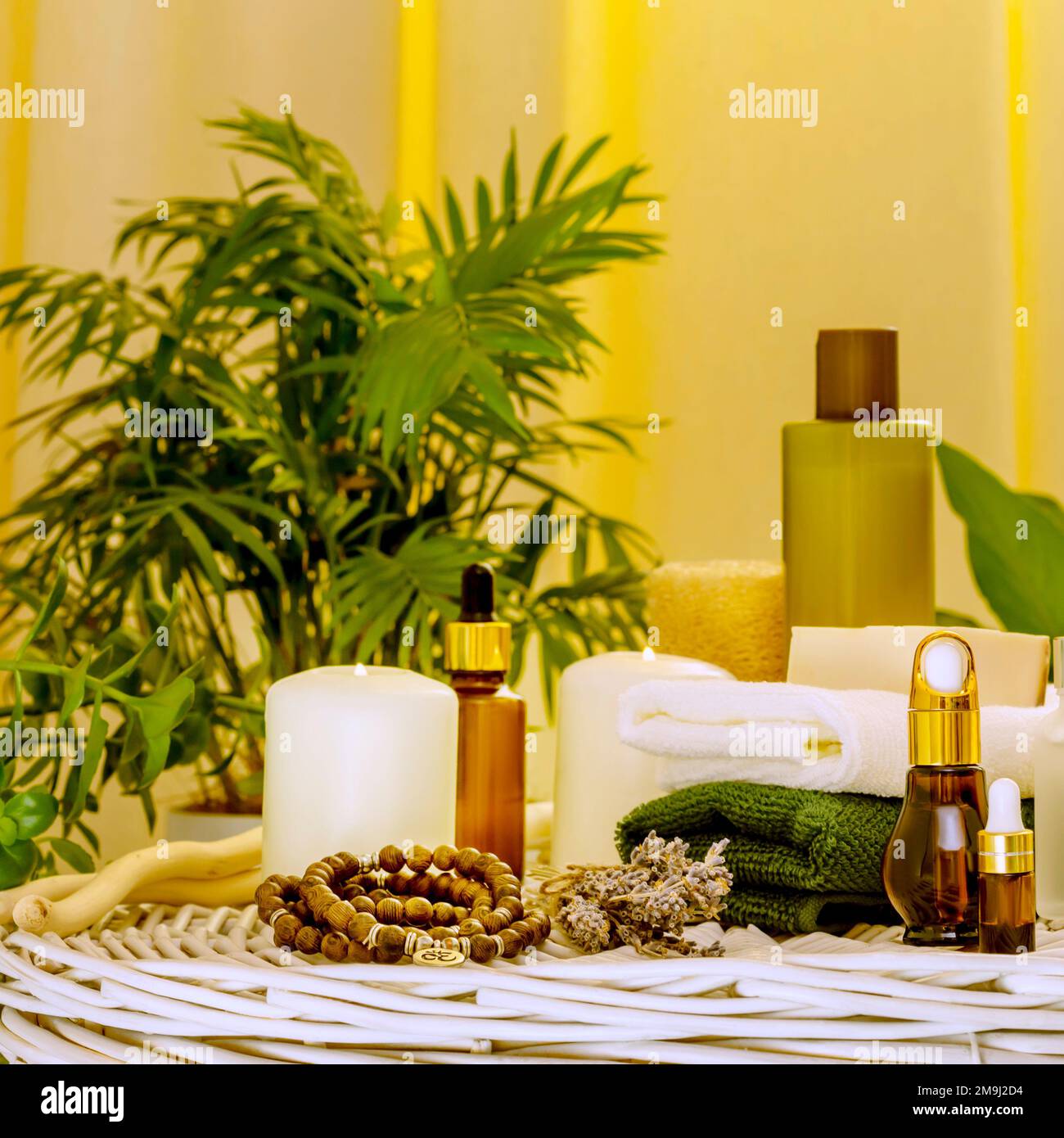 Spa relax still life with beauty products, spa accessories, towels and candles in home interior with plants. Concept of me time, self care and relaxin Stock Photo