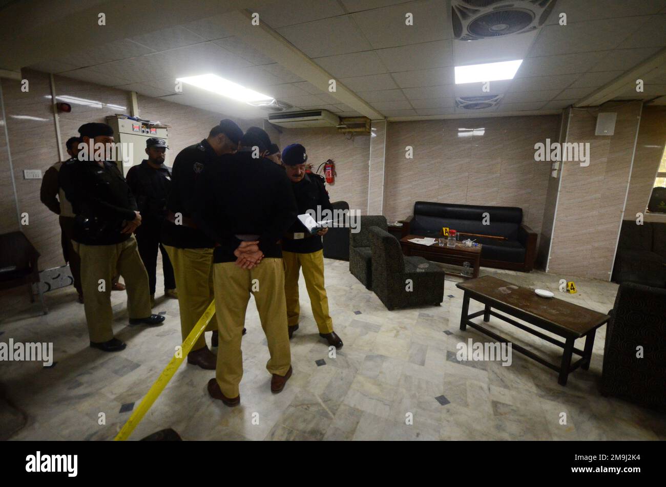 Pakistan. 16th Jan, 2023. Police officers examine the crime scene