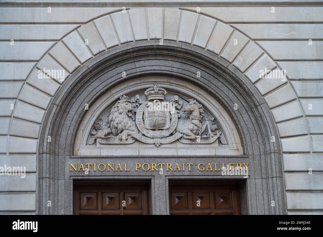 Carved stone coat of arms tympanum above the original doorway of the National Portrait Gallery. St Martin's Place, London, England, UK Stock Photo