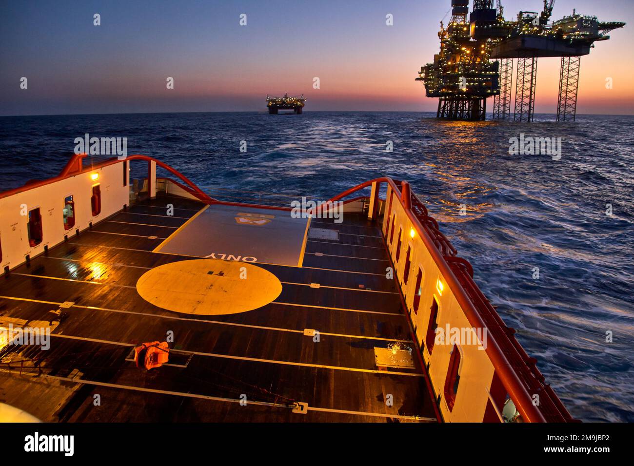 Supply vessel going for cargo operations for oil production plant. Dynamic positioning vessel going for cargo operations for jack up rig. Stock Photo