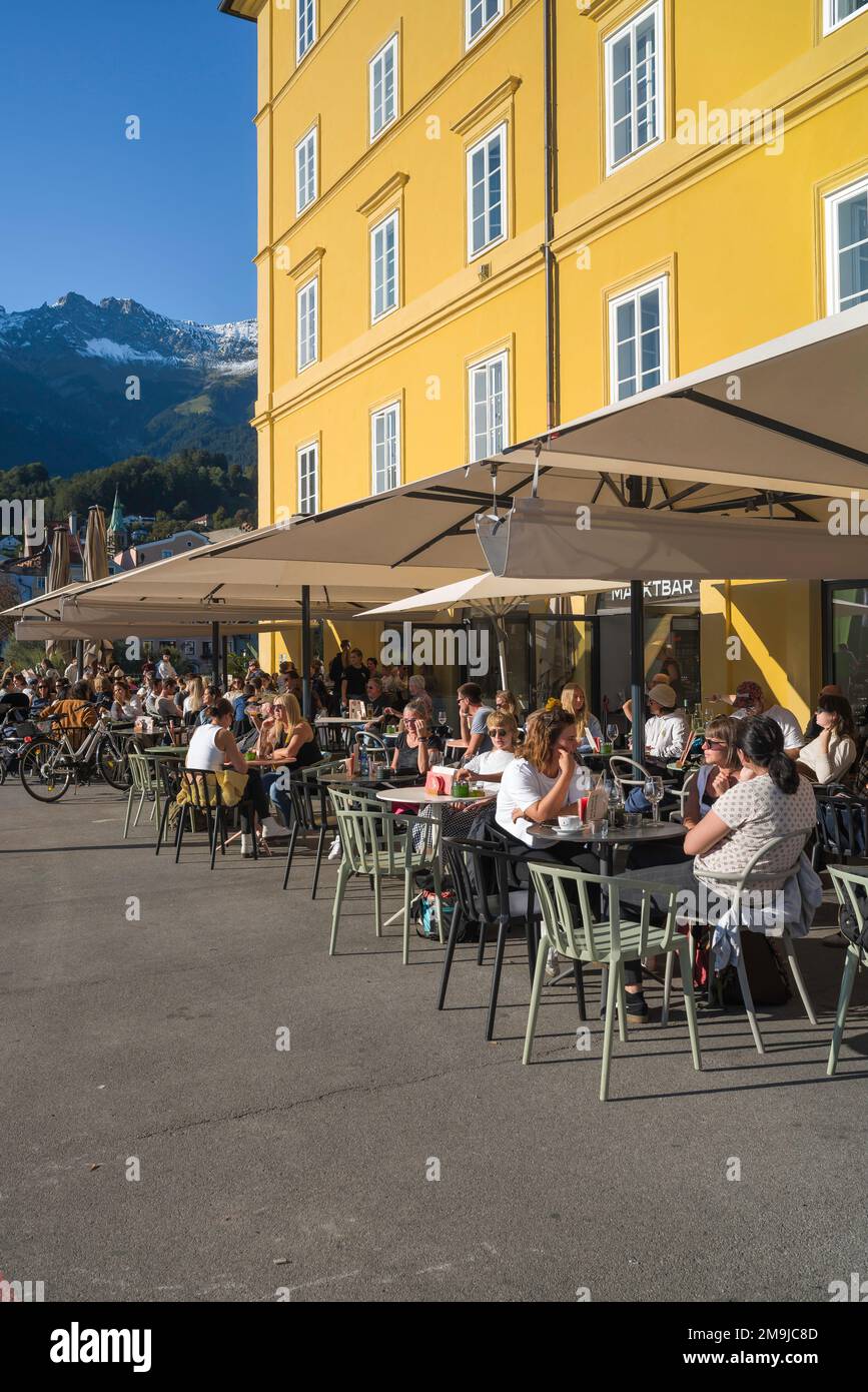 Innsbruck cafe bar, view in summer of people relaxing at cafe tables in Marktplatz in the historic old town center (Altstadt) of Innsbruck, Austria Stock Photo