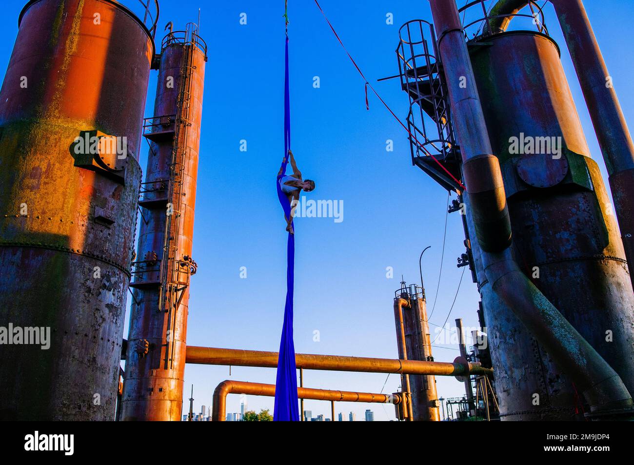 Acrobat on refinery pipes,  Bainbridge Island, Washington, USA Stock Photo