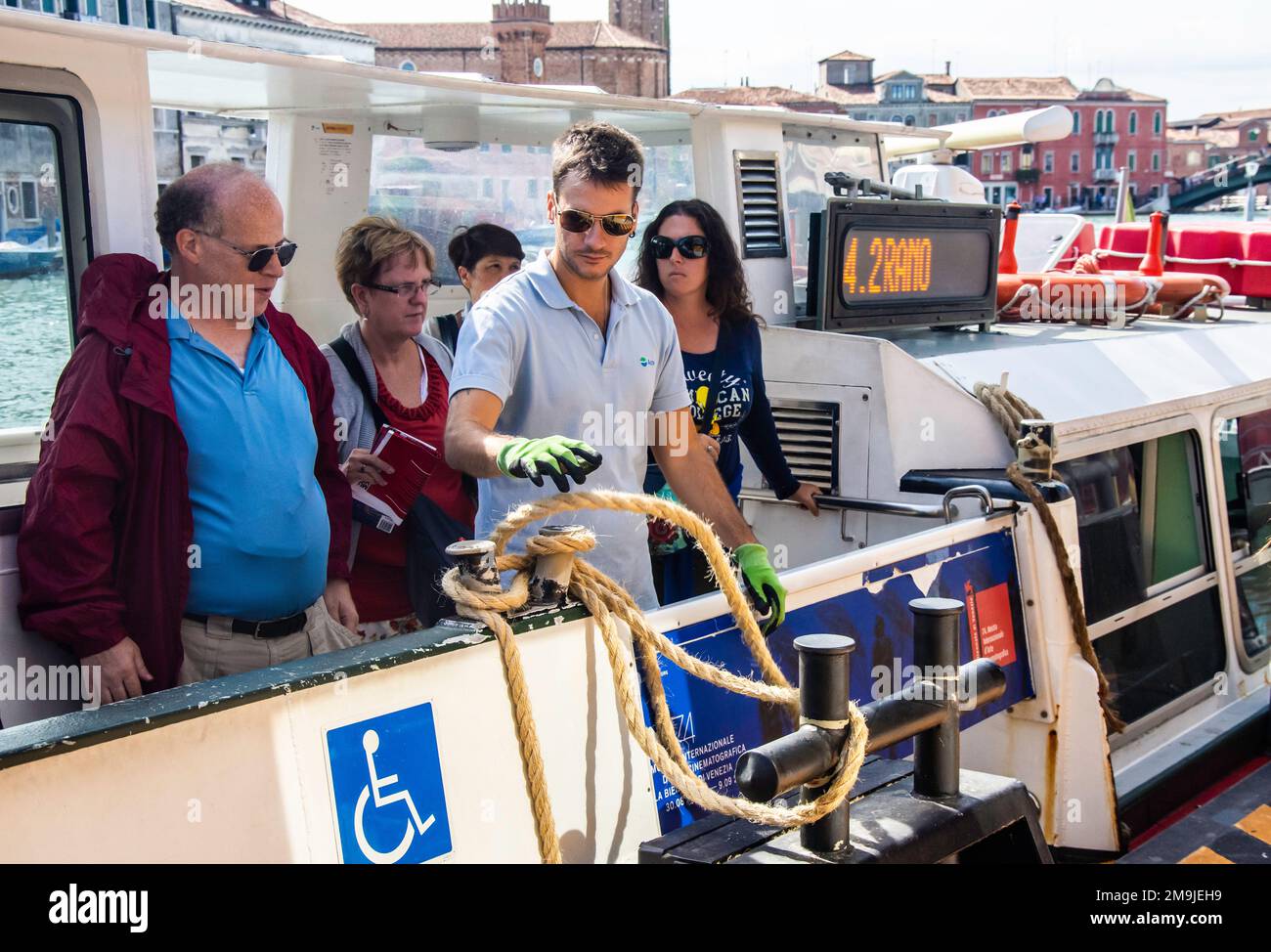 Tourists prepare to disembark a Vaporetti (Water Bus) in Venice, Italy Stock Photo